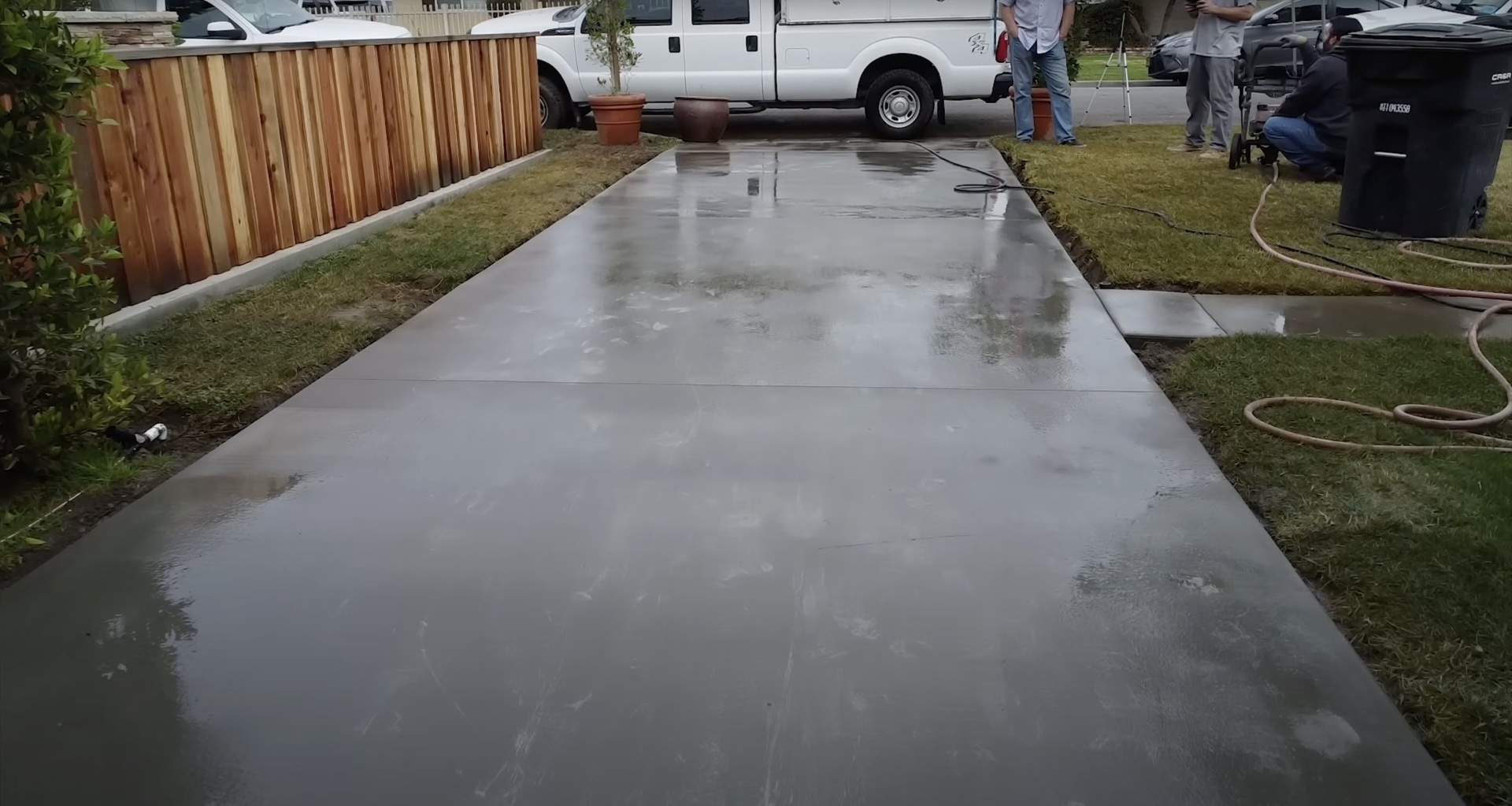 Professional concrete slab finishing with power equipment Fresh concrete slab being finished with professional equipment for smooth residential installation