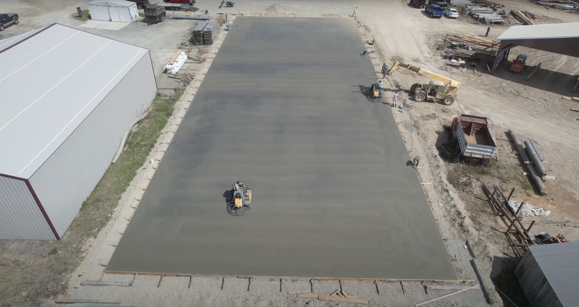 Commercial grade concrete finishing with professional equipment Large commercial concrete pour showing professional equipment and finishing